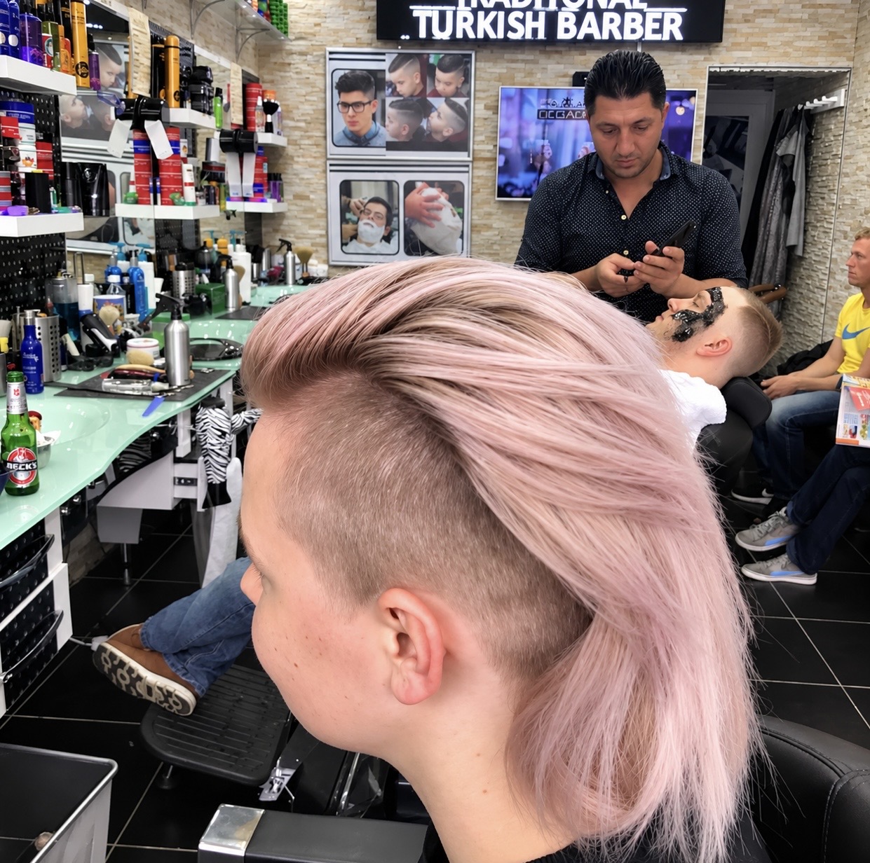 Barber working with customers inside Istanbul Turkish Barber