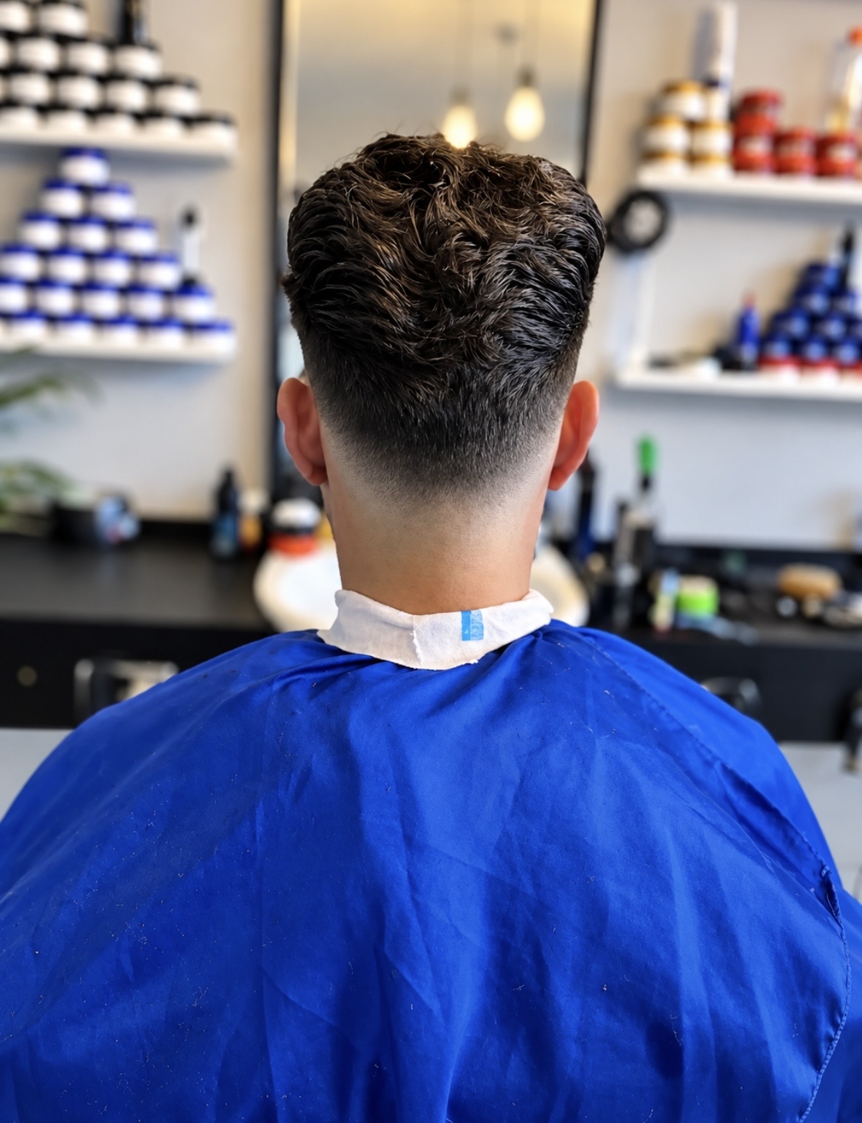 Freshly finished haircut showing a smooth taper and styled texture