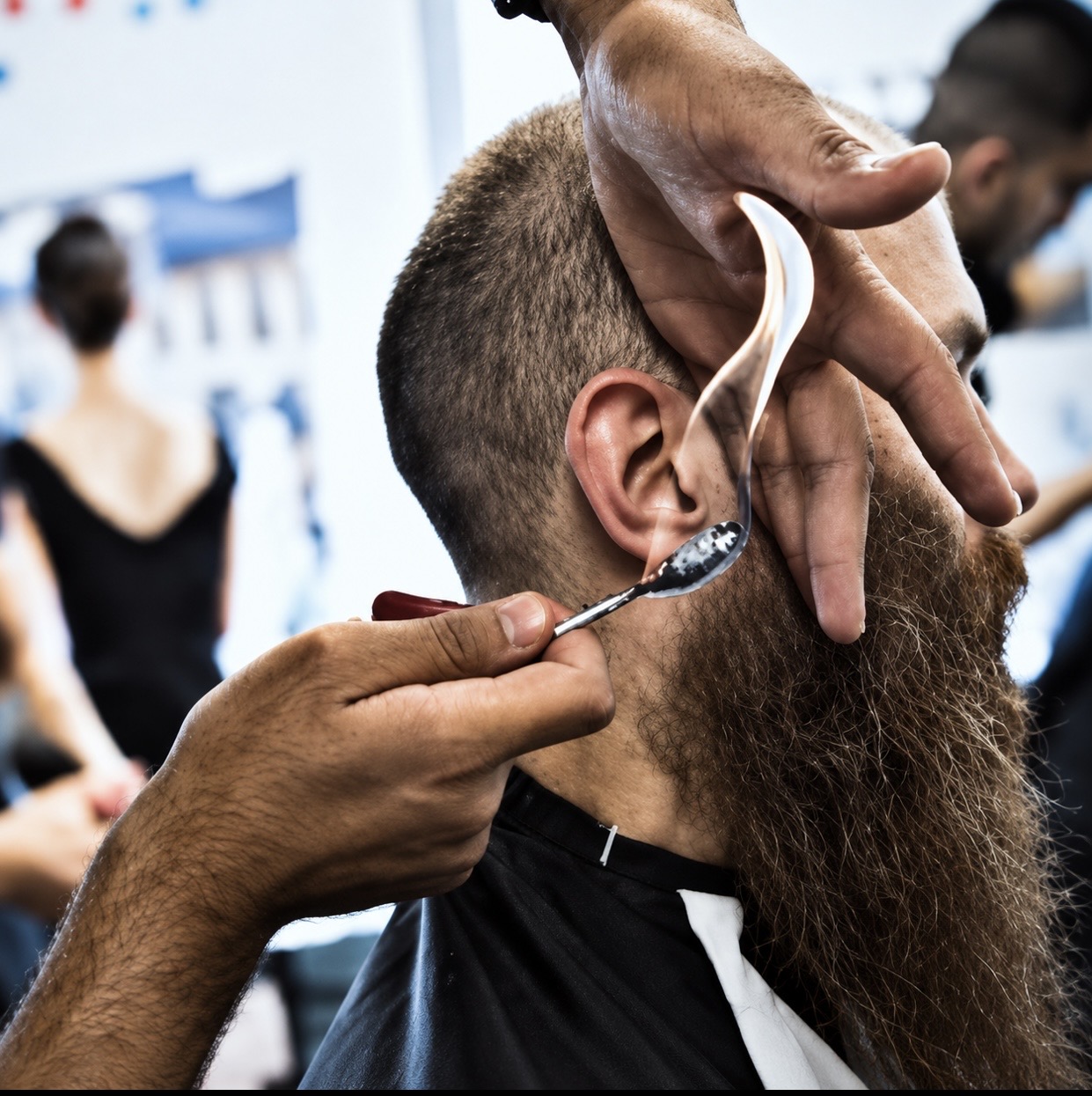 Traditional Turkish flame treatment being applied to a beard