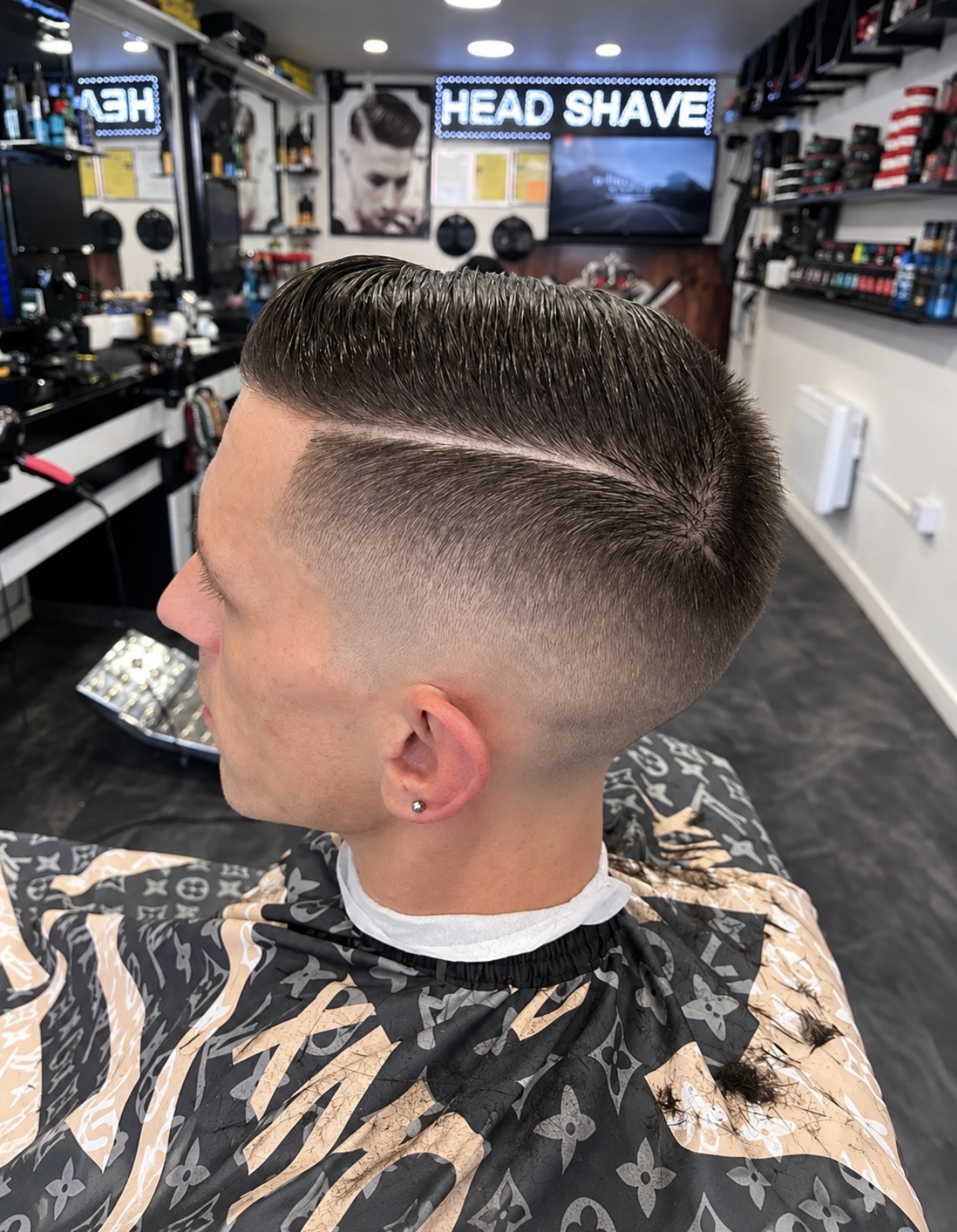 Precision skin fade with a sharply defined side part and styled top